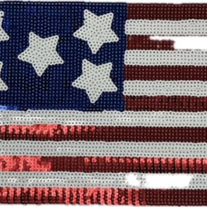 May include: A rectangular patch featuring a sequined American flag design. The left section is a blue field with five white sequined stars. The right and bottom sections consist of alternating horizontal red and white sequined stripes.