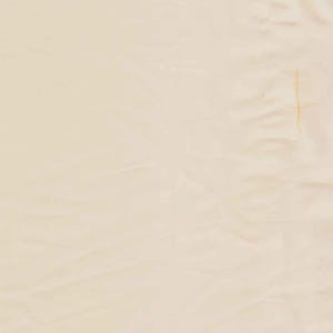 May include: A solid, light beige fabric with a smooth, slightly wrinkled texture. The material features a consistent, pale cream color throughout, with subtle folds and creases visible across the surface, creating a soft, matte appearance.