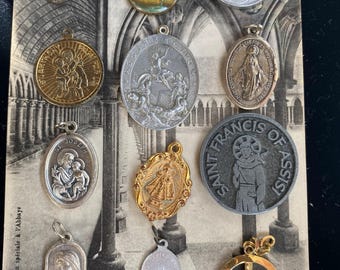 Lot of 12 vintage Catholic medals. Infant of Prague, St. Francis, Sacred Heart,  Miraculous Medals, Saint Joseph, Guardian Angel, and more.
