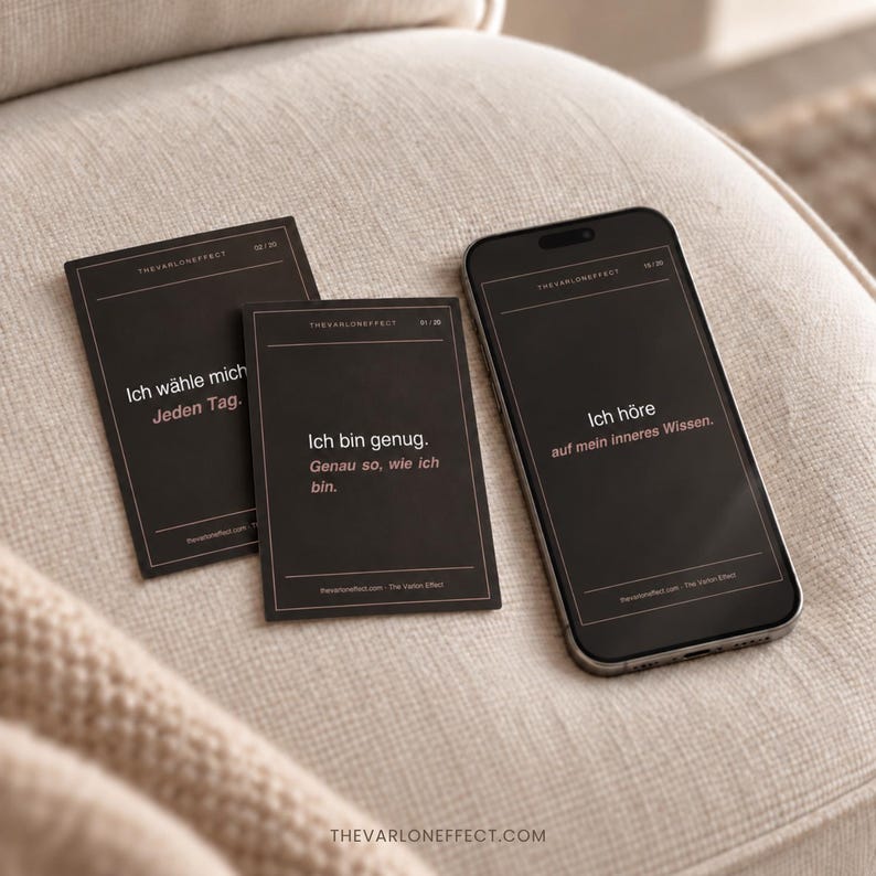 May include: Two rectangular black cards and a smartphone displaying black screens with white and light pink German text. The cards and phone feature the text THEVARLONEFFECT and affirmations including Ich w&auml;hle mich Jeden Tag, Ich bin genug, and Ich h&ouml;re auf mein inneres Wissen.