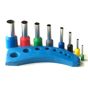 May include: A set of nine hole punches with different sizes, arranged in a blue plastic holder. The punches are color-coded with red, green, blue, and black.