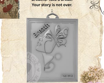May include: A rectangular gray wall plaque featuring a relief design of a profile face and a butterfly. The text "Breath" is embossed on the left, and "forever" is at the bottom. A small hanging loop is attached to the top center of the frame.