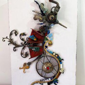 May include: A mixed-media wall art piece featuring a seahorse silhouette constructed from repurposed metal components, including pipes, gears, a circular fan grate, and red painted panels, mounted on a rectangular white board with a signature.