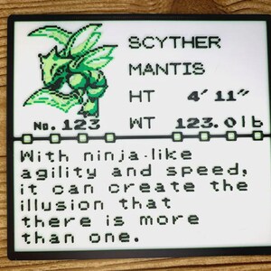 May include: A square white plaque featuring a pixelated green Scyther illustration, the text SCYTHER MANTIS, No. 123, HT 150 cm, WT 56 kg, and the description: With ninja-like agility and speed, it can create the illusion that there is more than one.