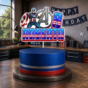 May include: A cake topper featuring Captain America, a large letter A, the number 8, and the name ROBERTO in red, white, and blue. The design includes star patterns and is mounted on a blue, silver, and red cylindrical cake base on a dark stand.