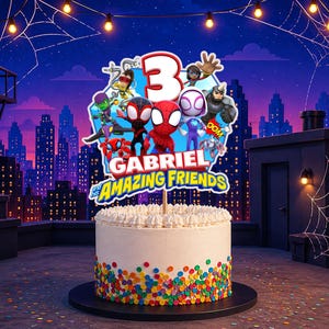 May include: A round white cake topper featuring the number 3 and cartoon characters including Spider-Man, with the text Gabriel and his Amazing Friends. The cake has white frosting and colorful round sprinkles around the base.