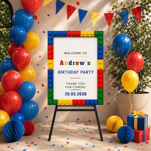 Può includere: Un cartello rettangolare per festa di compleanno con una cornice che ricorda mattoncini colorati. Il centro bianco riporta il testo: WELCOME TO Andrew's BIRTHDAY PARTY THANK YOU FOR COMING 20.05.2030. Il cartello poggia su un cavalletto nero.