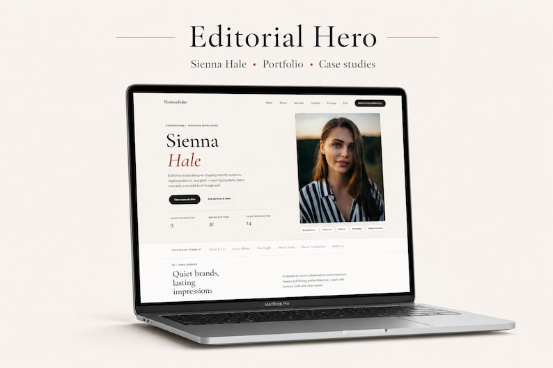 May include: A silver laptop displaying a website titled Editorial Hero for Sienna Hale. The screen shows a portfolio layout with a photograph of a person in a striped shirt, text sections, and navigation menus on a light beige background.