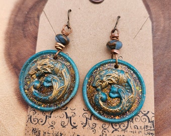 Hand poured resin earrings made from antique button mold