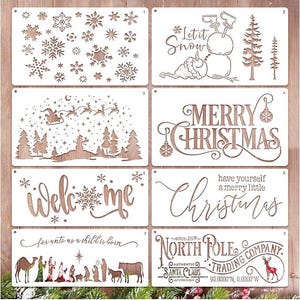 May include: A set of eight rectangular white stencils featuring holiday designs including snowflakes, a snowman with the text Let it Snow, a Santa sleigh, the text Merry Christmas, the word welcome, the text have yourself a merry little Christmas, a nativity scene with the text for unto us a child is born, and North Pole Trading Company text.