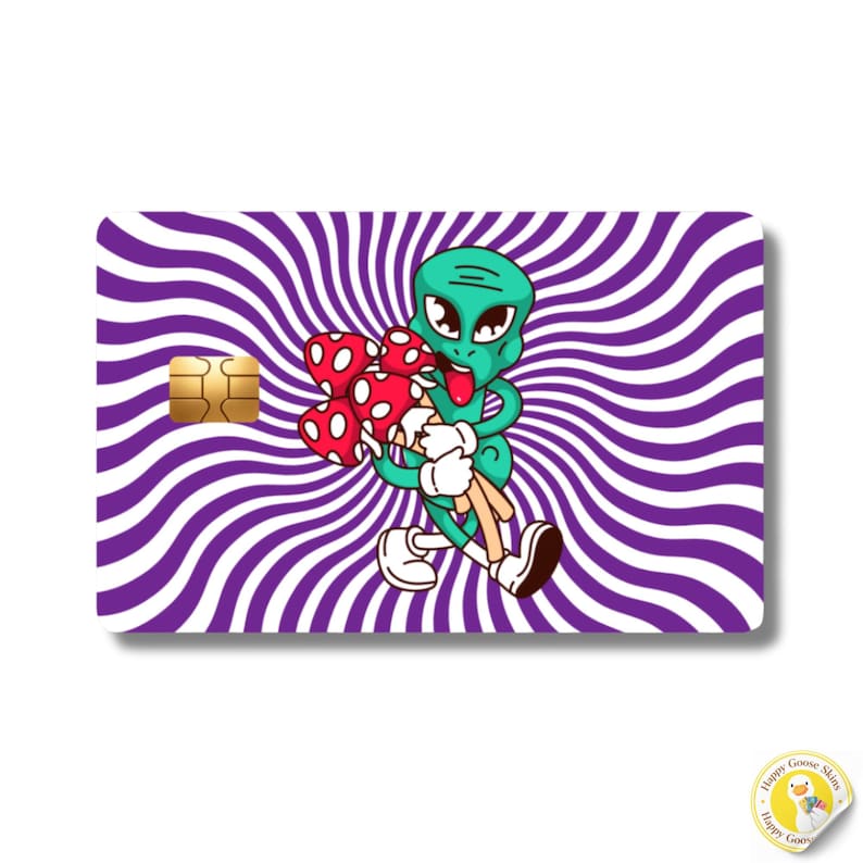 May include: A rectangular credit card skin featuring a purple and white radial swirl pattern. In the centre, a green cartoon alien with large eyes and a tongue sticking out holds a bouquet of red and white spotted mushrooms with white stems.