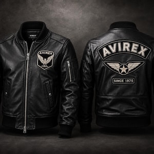 May include: A black leather bomber jacket shown from the front and back. The front features a small patch with an eagle and the text AVIREX. The back displays a large patch with the text AVIREX, a winged star emblem, and the text SINCE 1975.