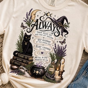 Può includere: Una t-shirt color crema con una stampa grafica di un gatto nero seduto su libri etichettati Herbs, Magic e Spells. Il design include un cappello da strega, una luna crescente, lavanda, rosmarino, un calderone, candele e il testo Always, Throw spilled salt over your left shoulder, Keep rosemary by your garden gate, Plant lavender for luck, and fall in love whenever you can.