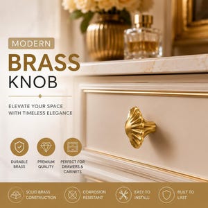 May include: A gold-coloured brass knob with a scalloped, shell-like design attached to a light-coloured drawer. The image includes text: MODERN BRASS KNOB, ELEVATE YOUR SPACE WITH TIMELESS ELEGANCE, DURABLE BRASS, PREMIUM QUALITY, PERFECT FOR DRAWERS & CABINETS.