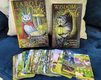 May include: Tarot deck box set featuring owls with a green, brown, and gold color scheme. The box set includes a guidebook and 78 cards. The title of the deck is "Tarot of the Owls" and "Wisdom of the Owls".