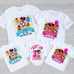 May include: A set of five white t-shirts and one white baby bodysuit featuring colorful cartoon illustrations of a family celebrating. The shirts include text banners reading DAD, MOM, BROTHER, SISTER OF THE BIRTHDAY GIRL, and BIRTHDAY GIRL 3 AURORA.