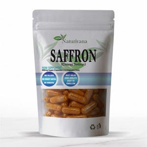 May include: A white stand-up pouch containing orange capsules labelled Naturivana Saffron Crocus Sativus. The packaging states 500mg Vegan Capsules, 1-2 Capsules Daily, and features circular icons noting no fillers, no heavy metal, and no binders.