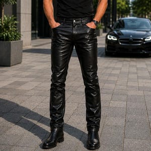 May include: A black short-sleeved crew neck t-shirt paired with black leather trousers featuring a button and zip fly closure, front pockets, and a straight-leg cut, worn with black leather boots and dark-tinted sunglasses.