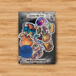 May include: A set of 10 glossy stickers featuring colorful illustrations of dragons, potions, and other fantasy elements. The stickers are packaged on a card with the text "Colour Me Fun" and "10 Glossy Stickers".