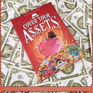 May include: The Cover Your Assets card game box features a red background with a pink piggy bank wearing a black bowler hat, surrounded by gold coins, a house, and a car. The text reads Cover Your Assets and Grandpa Beck's Games.