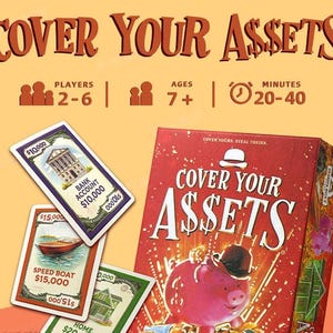 May include: The Cover Your Assets card game box features a red background with a pink piggy bank wearing a black bowler hat. Three game cards are displayed, showing a bank account, a speed boat, and a home. Text includes 2-6 players, ages 7+, and 20-40 minutes.