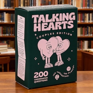 May include: A dark green rectangular game box titled Talking Hearts Couples Edition. The front features two light pink cartoon hearts with faces and limbs, 200 conversation questions, and text indicating 100 thoughtful and 100 playful cards.
