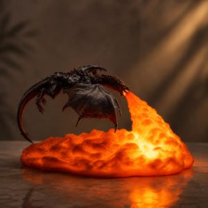 May include: A dark, textured dragon figurine in flight, suspended above a glowing, illuminated base that mimics a cloud of orange and yellow fire. The dragon features detailed scales and wings, while the base emits a warm, bright light.