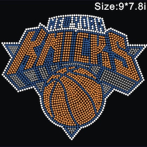 May include: A rhinestone transfer design featuring the New York Knicks logo with a basketball graphic, rendered in blue, orange, and silver crystals on a black background, with the text Size:9*7.8in visible in the upper right corner.