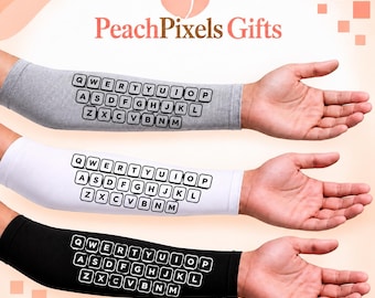 May include: Three arm sleeves in grey, white, and black, each featuring a printed QWERTY keyboard layout with black letters inside white rounded squares. The sleeves are worn on arms, displaying the full letter arrangement from Q to M.