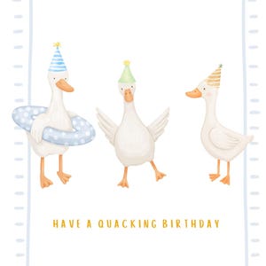 May include: A greeting card featuring three white ducks wearing colorful party hats. One duck holds a blue and white polka-dot swim ring. The text at the bottom reads HAVE A QUACKING BIRTHDAY. The card has a light blue dashed border.