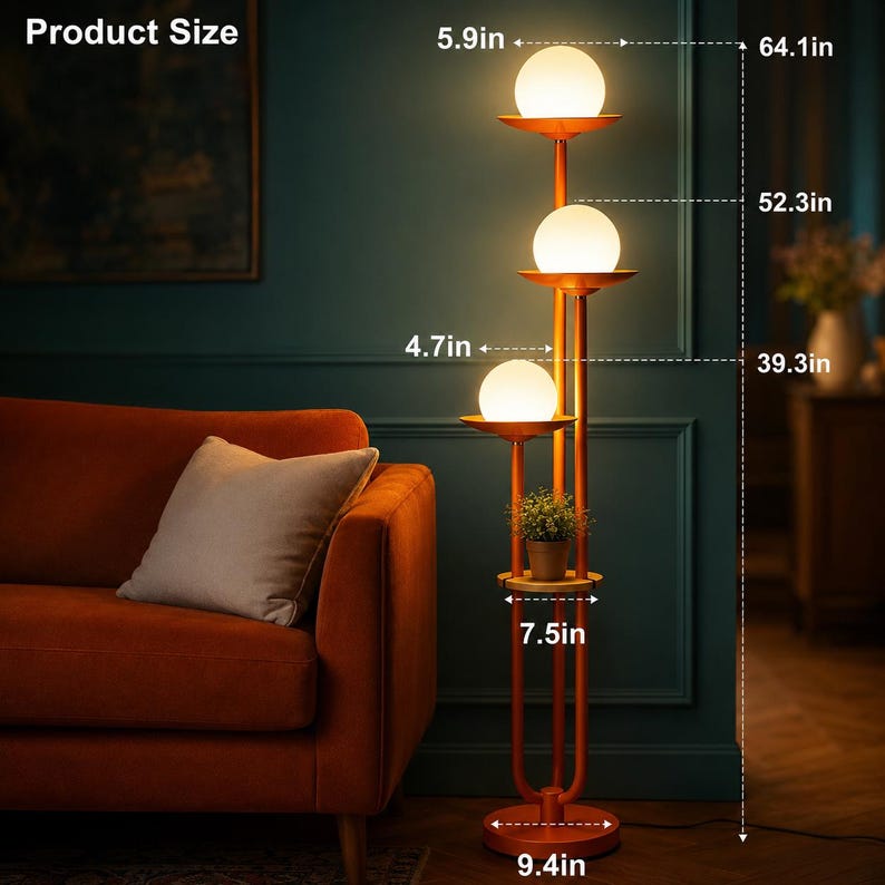 May include: A floor lamp with three white spherical glass shades and a small shelf holding a potted plant. The metal frame is orange. Dimensions are labeled as 64.1 inches total height, with 5.9 inch, 4.7 inch, and 7.5 inch width measurements.