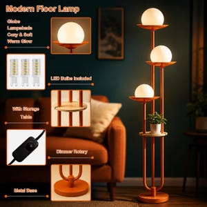May include: A modern floor lamp with an orange metal frame and three white globe lampshades emitting a warm glow. The lamp features a built-in wooden storage table, a rotary dimmer switch, and a circular metal base. Includes three LED bulbs.