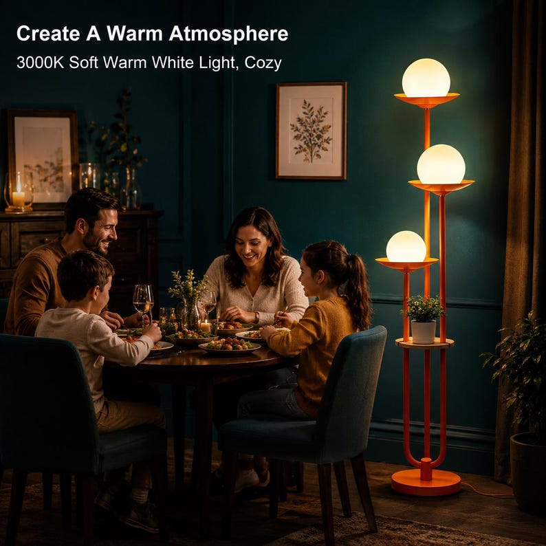 May include: A tall orange floor lamp featuring three vertical poles of varying heights, each topped with a spherical white glass globe light. The lamp includes a circular base and a small integrated shelf for plants, emitting a soft warm glow.