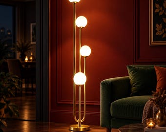 May include: A tall floor lamp featuring a slender gold-toned metal frame with four vertical stems of varying heights. Each stem is topped with a spherical white glass globe light, creating a tiered arrangement that emits a warm, soft glow.