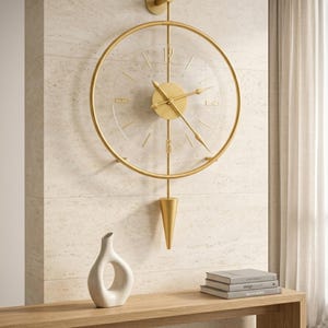 May include: A wall-mounted clock featuring a circular gold frame and a transparent face. The clock has gold hands, a central gold disc, and a vertical gold rod extending to a cone-shaped pendulum. The numbers 12 and 6 are displayed in gold.