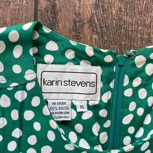 May include: A green and white polka dot rayon dress with a zipper closure and a label that reads "karin stevens" and "RN 69084 100% RAYON MADE IN HONG KONG CLEAN ONLY" and "16".