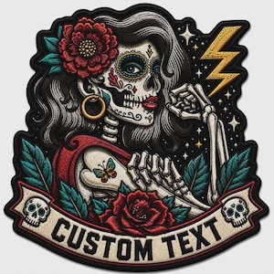 May include: An embroidered patch featuring a sugar skull figure with dark hair, a red flower, and a gold hoop earring. The design includes a yellow lightning bolt, a butterfly, green leaves, and a banner at the bottom with the text CUSTOM TEXT.