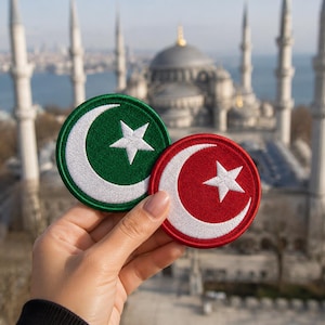 May include: Two circular embroidered patches featuring a white crescent moon and a five-pointed star. One patch has a deep green background, while the other has a vibrant red background. Both patches have a stitched border matching their base color.