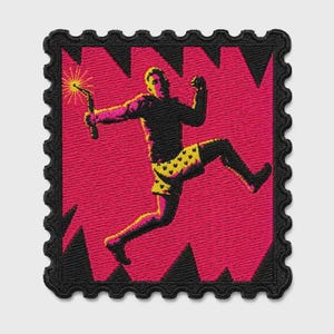 May include: A square embroidered patch with a scalloped edge featuring a black silhouette of a person jumping while holding a sparkler. The background is a vibrant magenta with black jagged shapes, and the person wears yellow patterned shorts.