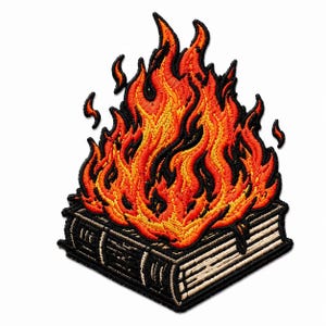 May include: An embroidered patch featuring a thick, closed book with a black cover and cream-colored pages. A large, vibrant flame in shades of bright orange, yellow, and red rises from the top of the book, outlined in thick black thread.