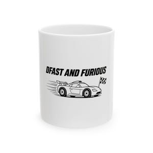 May include: A white ceramic mug featuring a black graphic of a sports car with a rear spoiler and a checkered flag. The car has motion lines behind it, and the text "DFAST AND FURIOUS" is printed in bold black capital letters above the car.