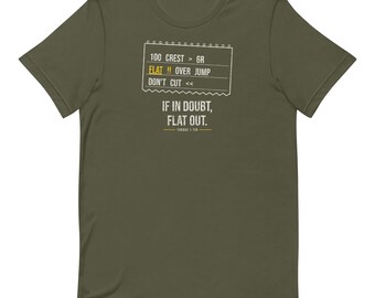 May include: An olive green t-shirt featuring a white graphic of rally pace notes. The text reads: 100 CREST > 6R, FLAT !! OVER JUMP, DON'T CUT <<, and IF IN DOUBT, FLAT OUT. The word FLAT is highlighted in yellow, and the brand name TORQUE & TIN is below.