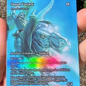 May include: A rectangular trading card featuring a blue-toned illustration of a metallic figure riding a mechanical creature. The text reads Doom Variant, Roaming Throne, Artifact Creature - Golem, Ward 2, and game rules with a holographic foil effect.