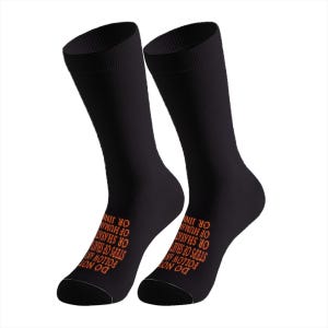 May include: A pair of black crew-length socks featuring orange text printed on the side. The text reads: DO NOT FOLLOW ANY STEPS OF SHAYTAN OR HUMAN OR JINN. The socks have a ribbed cuff at the top and a solid black toe and heel section.