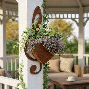 May include: A rust-colored metal wall planter shaped like a treble clef, mounted on a white wooden post. The planter is filled with green ivy vines and small purple flowers that spill over the edges of the musical note-shaped container.