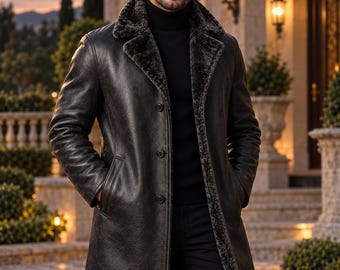 May include: A long, dark charcoal leather coat featuring a wide lapel collar lined with dark gray faux fur, a three-button front closure, and two side pockets. The coat is worn over a black turtleneck sweater and black trousers.