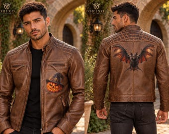 May include: A brown leather jacket featuring a quilted shoulder design and a front zipper closure. The front displays a graphic of a jack-o'-lantern wearing a witch hat, while the back features a large graphic of a bat with spread wings.