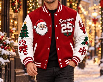 May include: A red and white varsity jacket featuring embroidered patches of a Santa Claus face, a Christmas tree, a candy cane, a reindeer, holly, a snowflake, and the text December 25. The jacket has white sleeves, a snap-button front, and striped ribbed cuffs.
