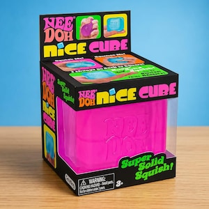 May include: A bright pink Nee Doh Nice Cube sensory toy inside a black cardboard display box. The packaging features the text Nee Doh Nice Cube, Super Solid Squish, and a warning label regarding small parts for children under 3 years of age.