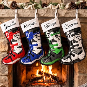 May include: Four Christmas stockings featuring a motocross boot design in red, blue, green, and black. Each white cuff is personalised with the names Jarvis, Nathan, Oliver, and Colton in black script. The boots display the Alpinestars logo.